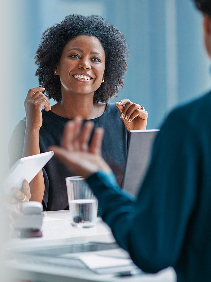 Business woman smiling in a meeting